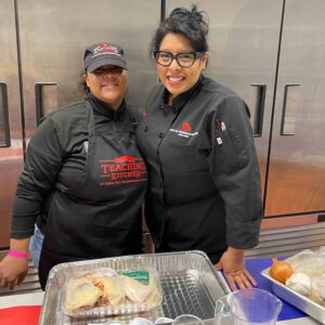 Naisha Scott, membership and aquatics director for The YMCA pauses for a smile with teaching kitchen Executive Chef Evelyn García at The Andy Murphy Neighborhood Center on Broadway in Kingston.